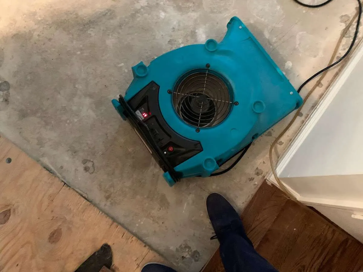 Air mover drying subfloor during Leak Detection & Repair in Indio